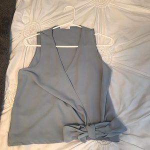 Light blue cross tank top with a bow.